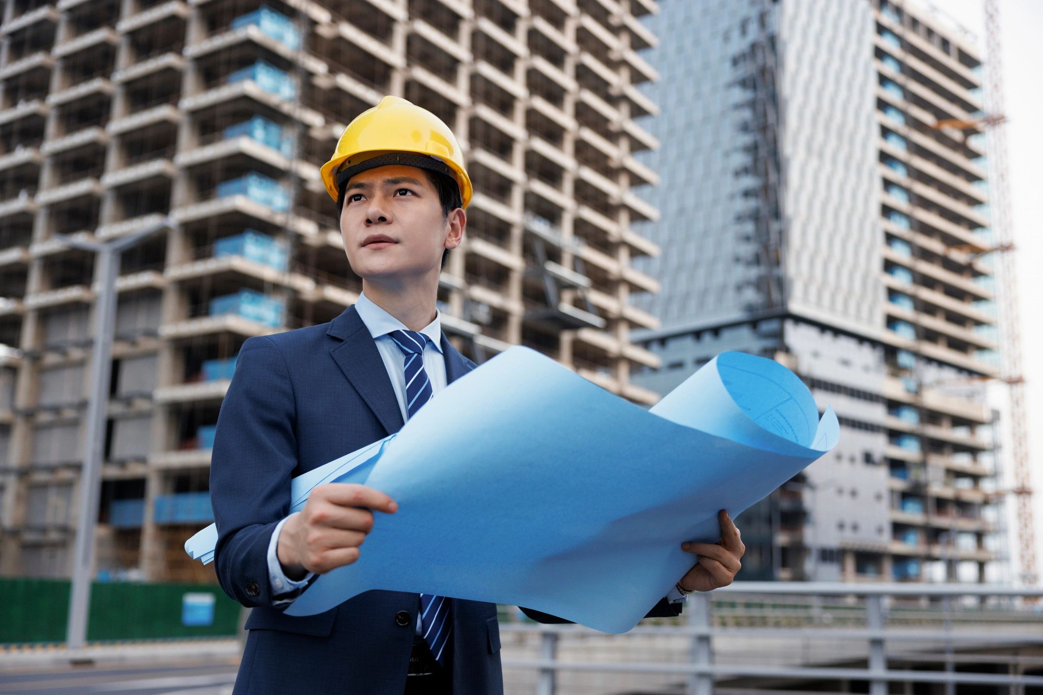 Electrical engineer reviewing construction drawings