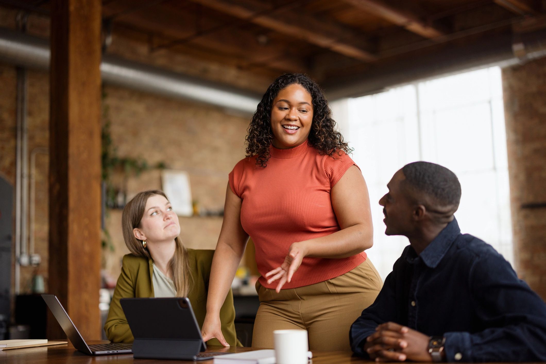 Professional in an office setting speaking with colleagues